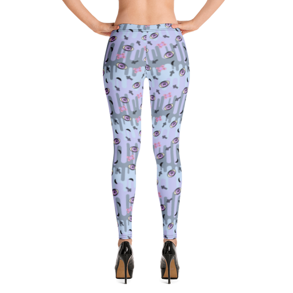 Pastel goth design harajuku leggings for women with a spooky pattern of eyeballs, crosses and black moons against a pastel drip design on these festival pants or running tights for women by BillingtonPix