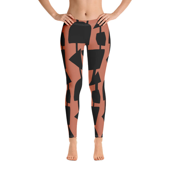 The vintage mid century modern style graphic design printed on the front of these patterned yoga leggings consists of abstract black geometric shapes connected vertically by black threads on an orange background