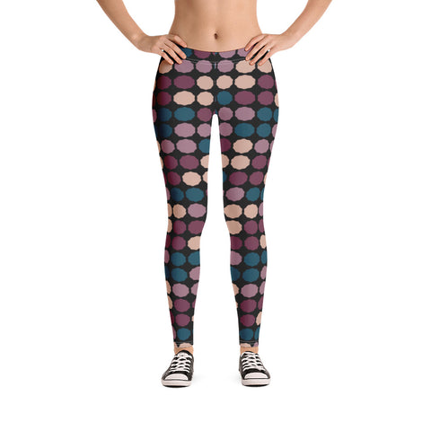 The vintage mid century modern style graphic design printed onto these colorful leggings consists of a colorful, abstract polka dots against a black background