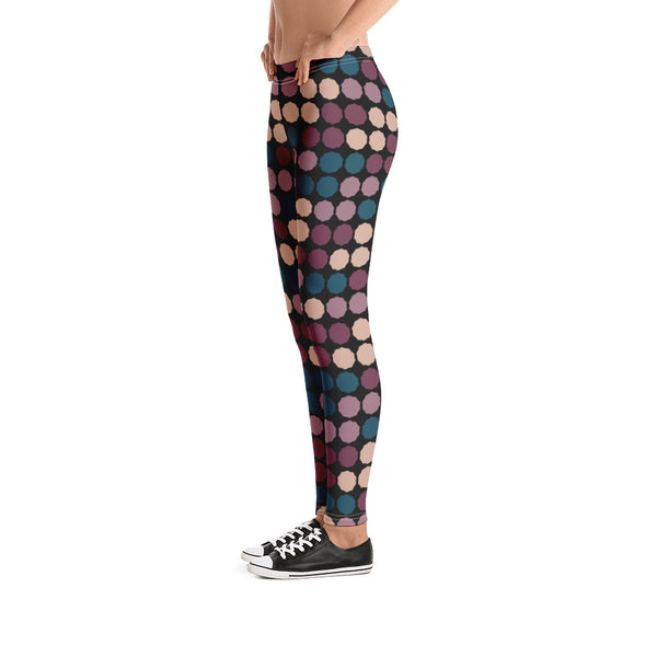 The vintage mid century modern style graphic design printed onto these colorful leggings consists of a colorful, abstract polka dots against a black background