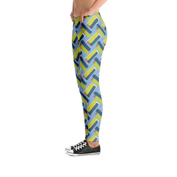 The vintage style graphic design printed on the front of these patterned leggings consists of diagonal color blocks in an alternating criss-cross format on a cerulean blue background