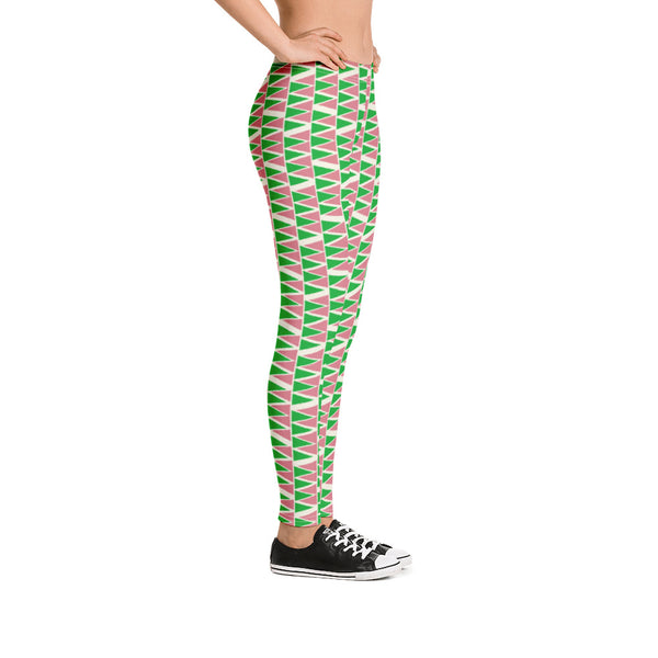The vintage mid century modern style graphic design printed onto these colorful leggings consists of a geometric triangular pattern in green and pink on a cream background