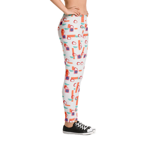 The vintage mid century modern style graphic design printed onto these all over print leggings consists of colourful geometric shapes in orange, turquoise, red and purple against a soft stone coloured background