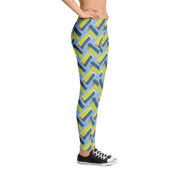 The vintage style graphic design printed on the front of these patterned leggings consists of diagonal color blocks in an alternating criss-cross format on a cerulean blue background