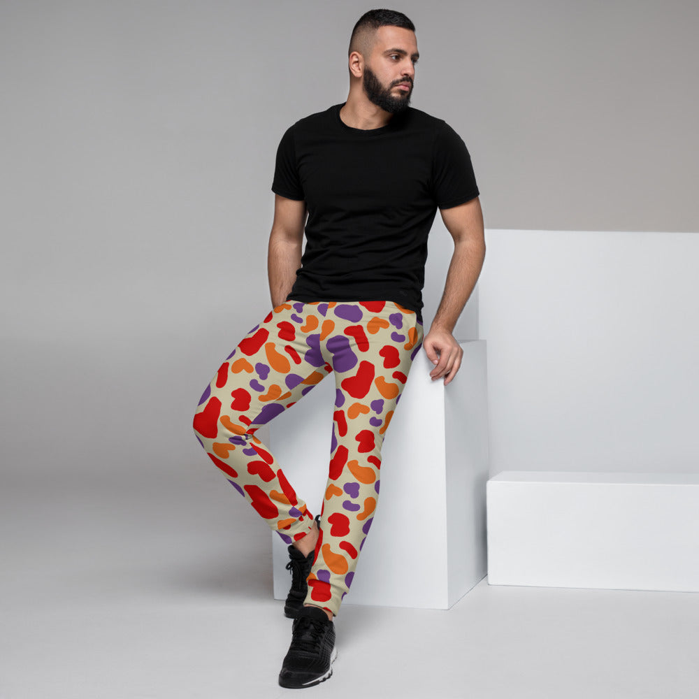 Retro 90s style camouflage patterned joggers for men in red, purple and orange abstract shapes by BillingtonPix
