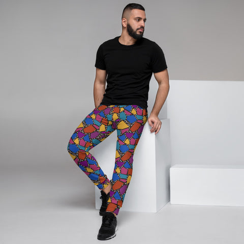 Multicoloured geometric shapes in tones of mustard, teal, purple , yellow and orange on a black background joggers or sweatpants by BillingtonPix