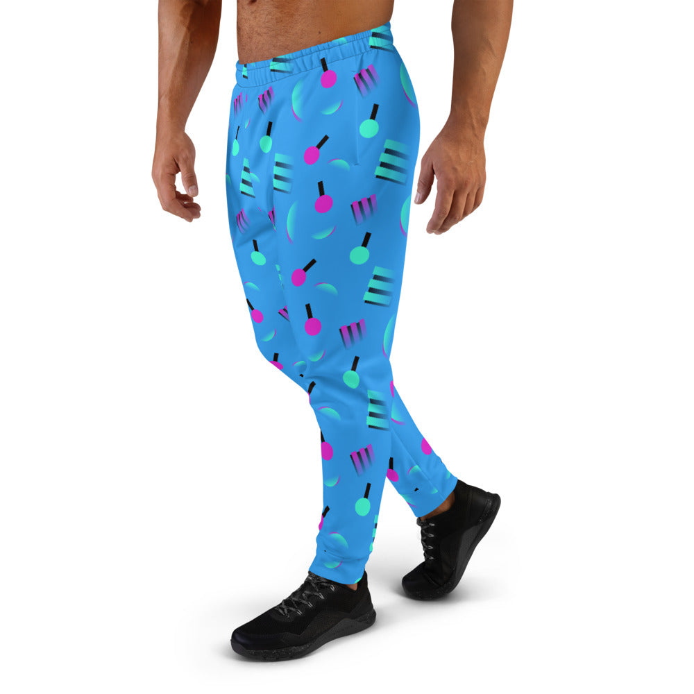 Retrowave style 80s Memphis and Vaporwave patterned men's joggers or sweats with geometric pink and turquoise shapes against a blue background on these men's running joggers or sweatpants by BillingtonPix