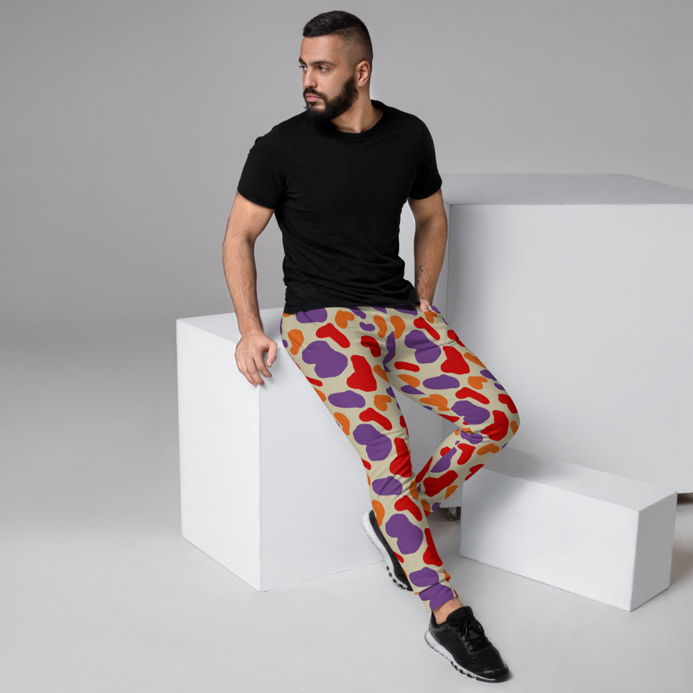 Retro 90s style camouflage patterned joggers for men in red, purple and orange abstract shapes by BillingtonPix