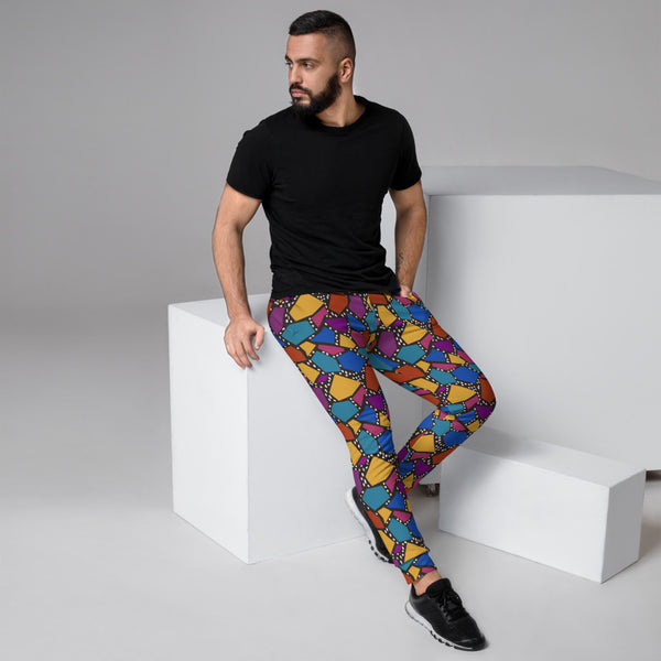 Multicoloured geometric shapes in tones of mustard, teal, purple , yellow and orange on a black background joggers or sweatpants by BillingtonPix