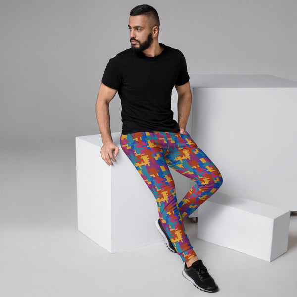 Striking 90s style geometric patterned men's joggers for jogging, running, squatting, gym, lounging or streetwear fashion in multicoloured shapes of teal, mustard, red and magenta by BillingtonPix