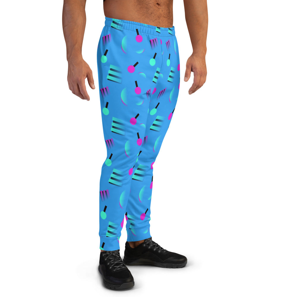 Retrowave style 80s Memphis and Vaporwave patterned men's joggers or sweats with geometric pink and turquoise shapes against a blue background on these men's running joggers or sweatpants by BillingtonPix