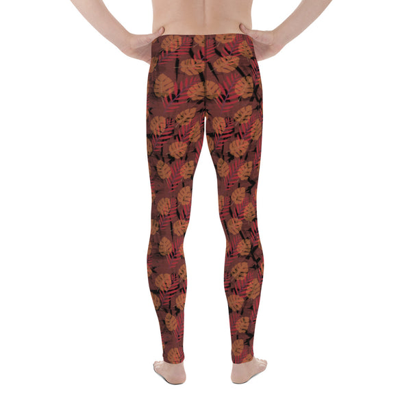 Orange and black autumnal monstera and fern leaves pattern on these spandex and polyester men's leggings by BillingtonPix
