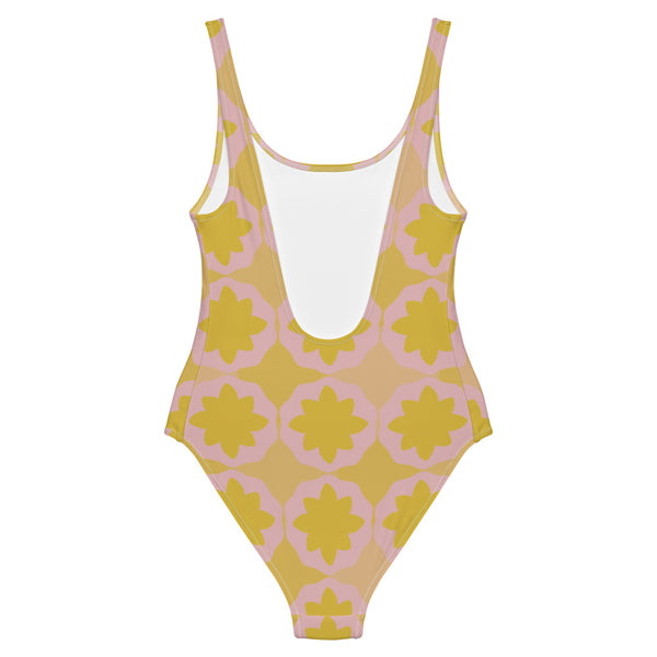 This cheeky, nude-toned and comfortable, abstract design patterned one-piece swimsuit is entitled Geometric Flock and consists of a colorful, abstract geometric floral design in pink and yellow/orange tones