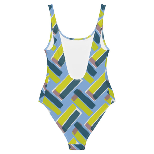 This cheeky, stylish and comfortable, abstract design patterned swimsuit is entitled Forever Connected and consists of diagonal color blocks in an alternating criss-cross format on a cerulean blue background