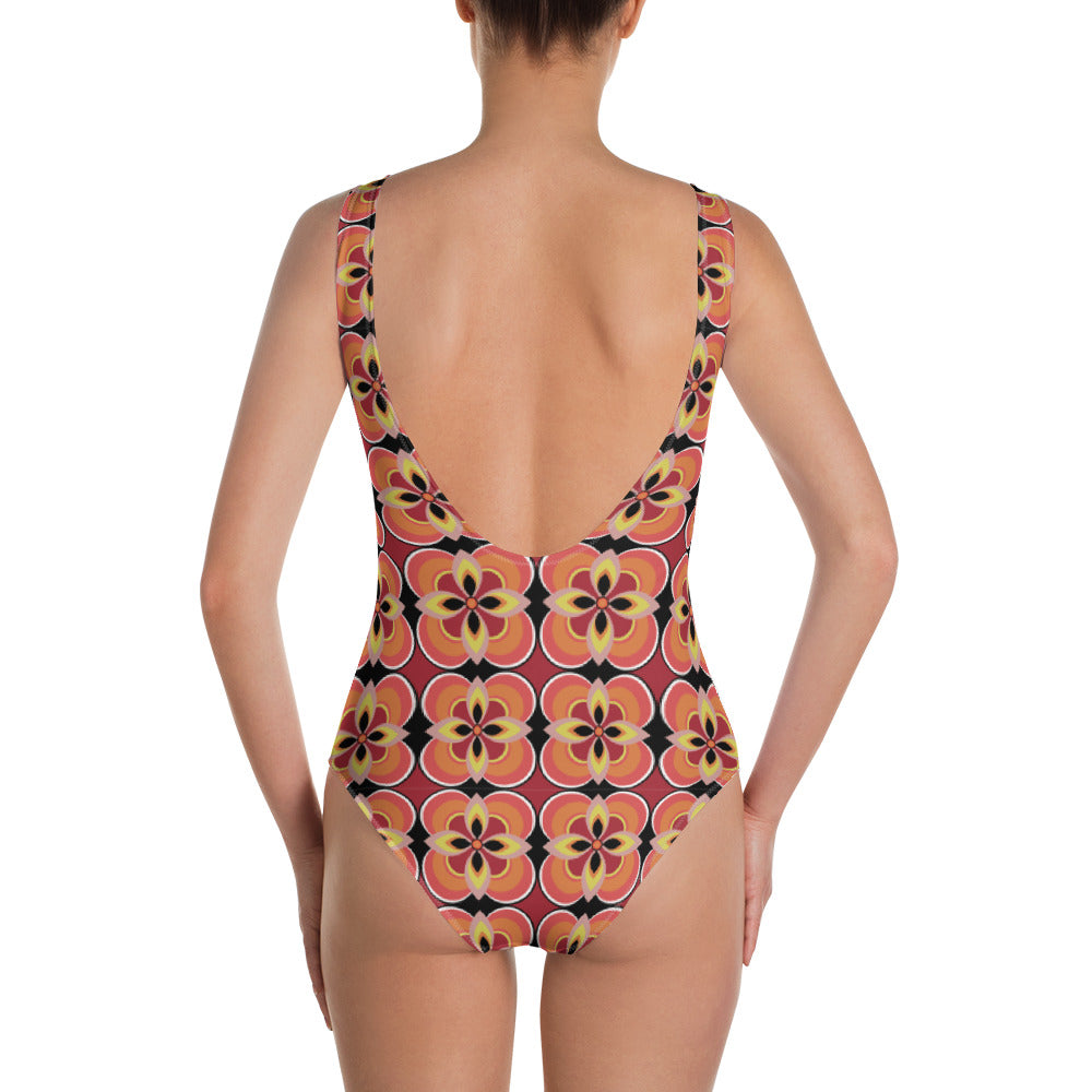 Kitsch vintage retro style one piece swimsuit for women in an abstract floral design in tones of orange, tan, yellow and black