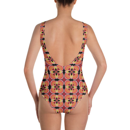 Kitsch vintage retro style one piece swimsuit for women in an abstract floral design in tones of orange, tan, yellow and black