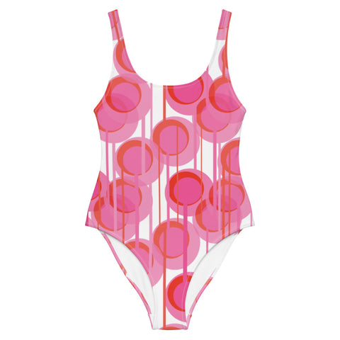 This cheeky, bright and comfortable abstract design patterned swimsuit is entitled Pink Connected Circles and consists of colorful geometric circular shapes in various tones of pink on a white background, connected vertically by narrow tentacles, to form a hanging mobile pattern