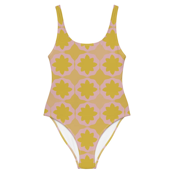 This cheeky, nude-toned and comfortable, abstract design patterned one-piece swimsuit is entitled Geometric Flock and consists of a colorful, abstract geometric floral design in pink and yellow/orange tones