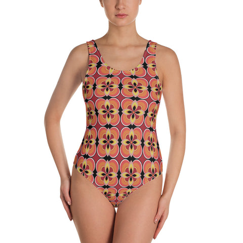 Kitsch vintage retro style one piece swimsuit for women in an abstract floral design in tones of orange, tan, yellow and black