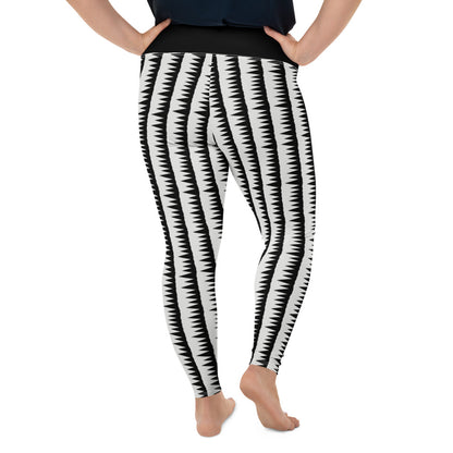 These Mid-Century Modern style plus size leggings pattern consists of black jagged columns of geometric triangular shapes stacked upon each other like columns against a pale cream background. A black high waistband completes the look.