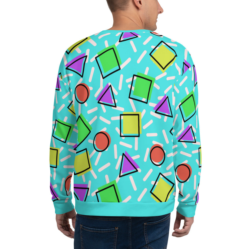 Retro style 80s Memphis design sweatshirt pullover with colourful rainbow primary colors in geometric shapes squares, circles. triangles with a random white pattern below all over a turquoise blue background on this best athleisure sportswear sweatshirt by BillingtonPix