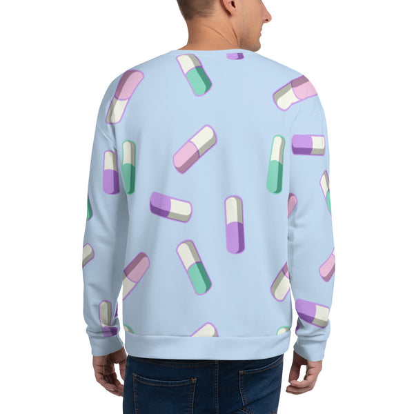 Harajuku Fairy Kei sweater with a pattern of kawaii pills in pastel colours of purple, green and pink against a pale blue background on this unisex sweatshirt by BillingtonPix