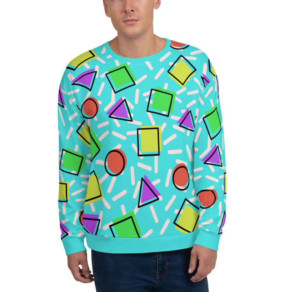 Retro style 80s Memphis design sweatshirt pullover with colourful rainbow primary colors in geometric shapes squares, circles. triangles with a random white pattern below all over a turquoise blue background on this best athleisure sportswear sweatshirt by BillingtonPix