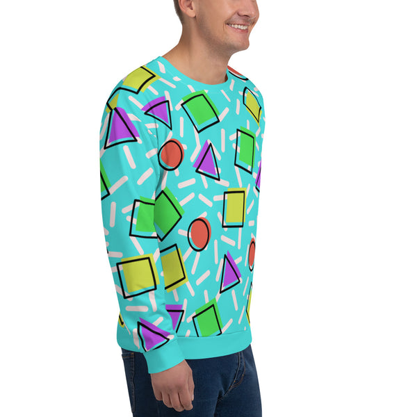 Retro style 80s Memphis design sweatshirt pullover with colourful rainbow primary colors in geometric shapes squares, circles. triangles with a random white pattern below all over a turquoise blue background on this best athleisure sportswear sweatshirt by BillingtonPix