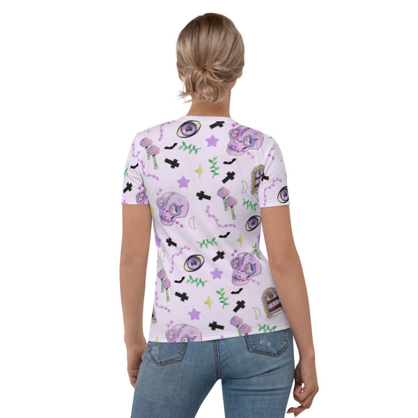 Pastel pink t-shirt for women in Harajuku pastel goth style. Features spooky skulls, crosses, mushrooms , grottos and stars on this Halloween all over print t-shirt by BillingtonPix