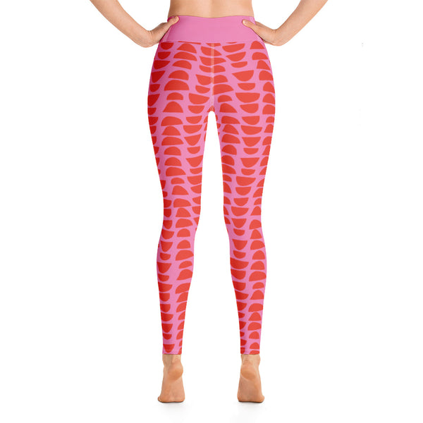 The colorful yoga tights have a patterned retro mid century modern style design with stacked abstract shapes in stunning red alternating in reverse against a gorgeous pink background.