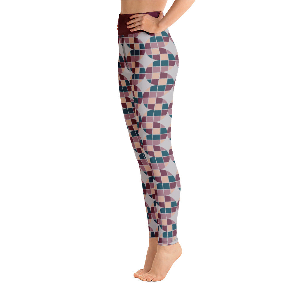 These Mid-Century Modern style yoga leggings consists of a mosaic pattern of burgundy, teal, pink and cream in the abstract shape of descending serpents against pale grey background. The high waistband is kept simple, picking out the burgundy colour in these distinctive patterned yoga tights