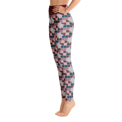 These Mid-Century Modern style yoga leggings consists of a mosaic pattern of burgundy, teal, pink and cream in the abstract shape of descending serpents against pale grey background. The high waistband is kept simple, picking out the burgundy colour in these distinctive patterned yoga tights