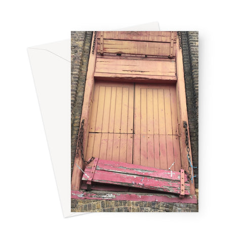 Old doors in painted orange and pink of a Victorian factory