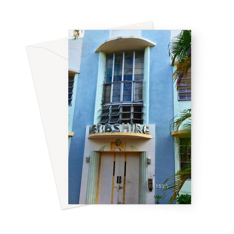 This greeting card shows an interesting Art Deco blue frontage with a large window, gold or brass detailing, pale blue columns and half-moon sills.