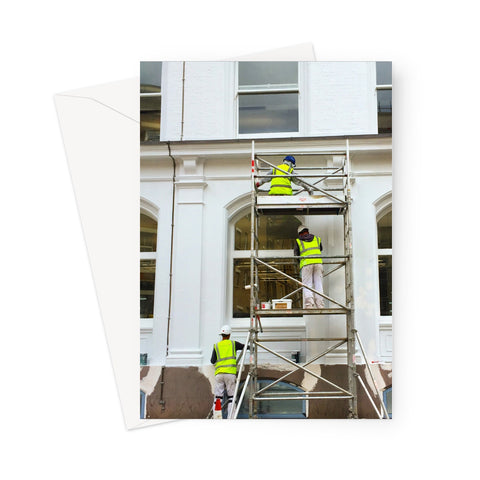 Greeting card showing three decorators on scaffolding, dressed in high-vis jackets, decorating a white period building