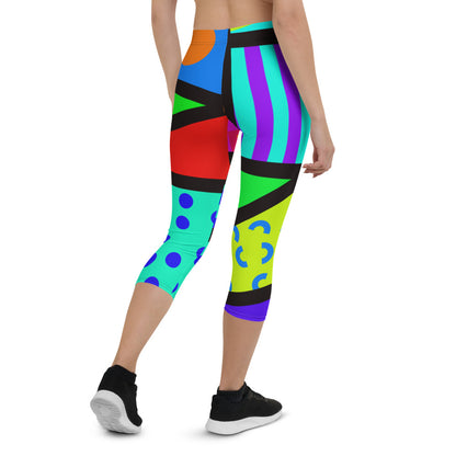 Capri leggings for women in a retro 80s Memphis design. Rainbow colored geometric all-over pattern with black overlay. Calf length legs and mid-rise elastic waistband.