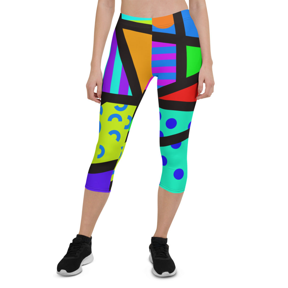 Capri leggings for women in a retro 80s Memphis design. Rainbow colored geometric all-over pattern with black overlay. Calf length legs and mid-rise elastic waistband.