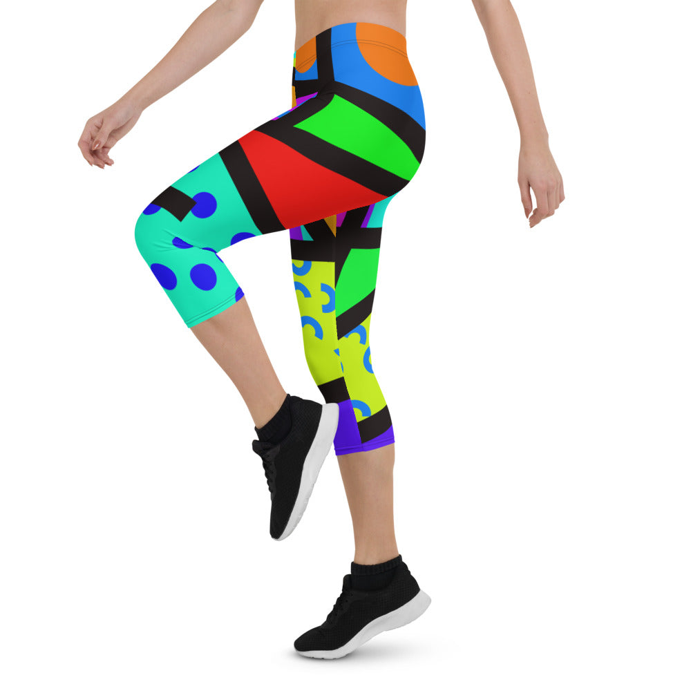 Capri leggings for women in a retro 80s Memphis design. Rainbow colored geometric all-over pattern with black overlay. Calf length legs and mid-rise elastic waistband.