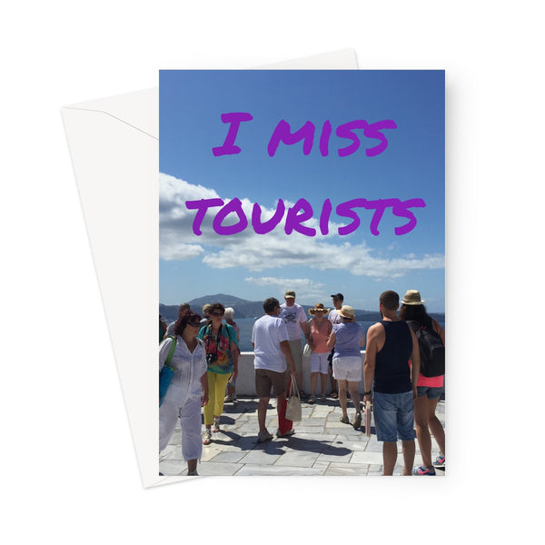 Greeting card showing the phrase "I miss tourists" in purple, overlaying an image of tourists on Santorini obscuring the view of the caldera