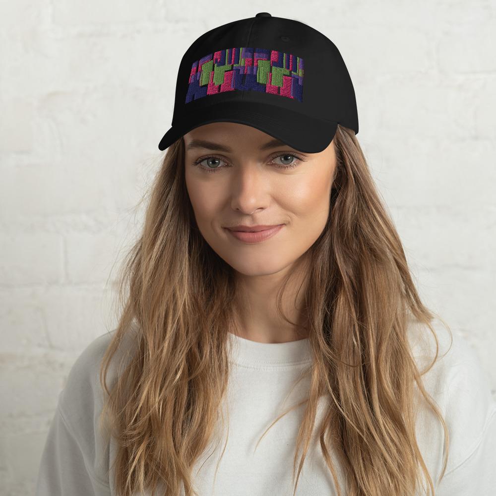 Black colored dad hat with retro 60s style geometric pattern logo in threads of lime green, pink, purple and indigo