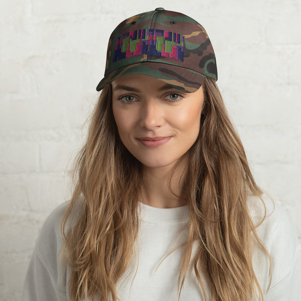 Camo colored dad hat with retro 60s style geometric pattern logo in threads of lime green, pink, purple and indigo