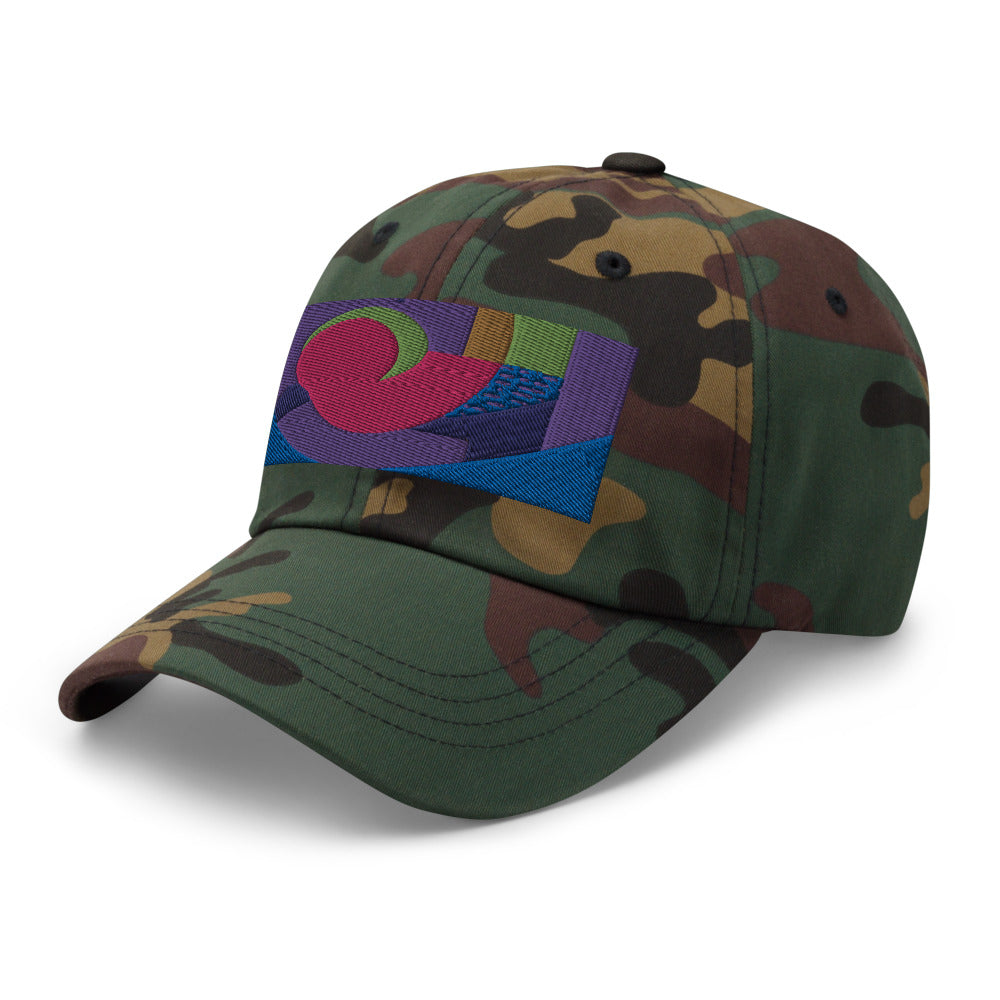 Green camo dad hat with colorful rectangular logo containing blocks of colors of pink, purple, green and blue, curves and geometric shapes in a mid-century modernist abstract composition