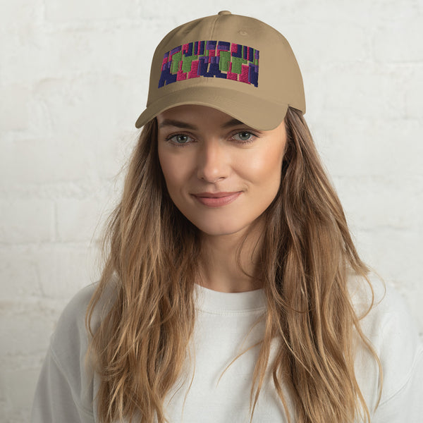 Khaki colored dad hat with retro 60s style geometric pattern logo in threads of lime green, pink, purple and indigo