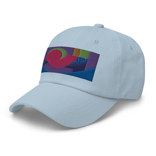 Light blue dad hat with colorful rectangular logo containing blocks of colors of pink, purple, green and blue, curves and geometric shapes in a mid-century modernist abstract composition
