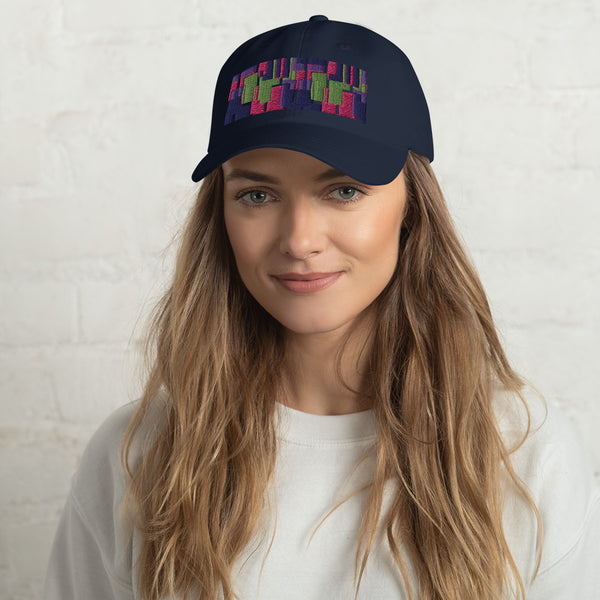 Navy colored dad hat with retro 60s style geometric pattern logo in threads of lime green, pink, purple and indigo