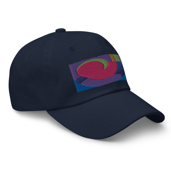 Navy dad hat with colorful rectangular logo containing blocks of colors of pink, purple, green and blue, curves and geometric shapes in a mid-century modernist abstract composition