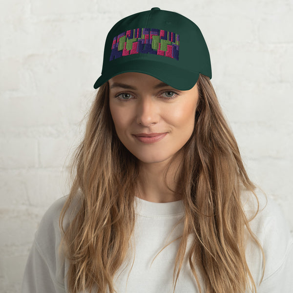 Spruce green colored dad hat with retro 60s style geometric pattern logo in threads of lime green, pink, purple and indigo