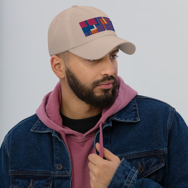 Colorful pink, orange, purple and blue geometric shapes patterned rectangular logo on this stone colored dad hat