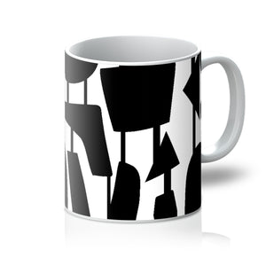This Mid-Century Modern style ceramic coffee mug consists of colorful connected shapes in black on a white background