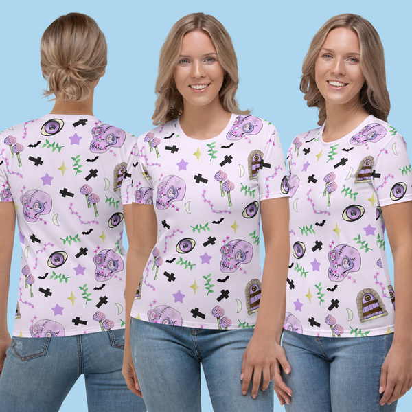 Pastel pink t-shirt for women in Harajuku pastel goth style. Features spooky skulls, crosses, mushrooms , grottos and stars on this Halloween all over print t-shirt by BillingtonPix
